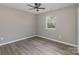 Spacious bedroom with ceiling fan and large window at 201 School St, High Shoals, NC 28077