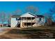 Newly constructed home with a gray exterior, front porch, and steps leading to the entrance at 201 School St, High Shoals, NC 28077