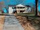 House exterior showcasing a front porch and a long driveway at 201 School St, High Shoals, NC 28077