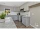 Modern kitchen with gray cabinets, granite countertops and white backsplash at 201 School St, High Shoals, NC 28012