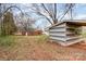 Exterior backyard view of red brick home with gray and white striped shed at 2209 Dale Ave, Lincolnton, NC 28092