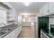 Galley kitchen with stainless steel appliances and white cabinets at 2209 Dale Ave, Lincolnton, NC 28092