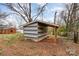 An exterior view of gray and white striped shed with open side porch at 2209 Dale Ave, Lincolnton, NC 28092