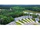 Aerial view of homes in a neighborhood surrounded by lush green trees and a lake at 25622 Seagull Dr # 645, Lancaster, SC 29720