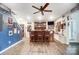 Finished basement with a custom-built wet bar featuring a wood bar, stools, and a ceiling fan at 25622 Seagull Dr # 645, Lancaster, SC 29720