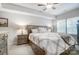 Well-lit bedroom with a decorative lamp on a nightstand, neutral decor, and natural light from a large window at 25622 Seagull Dr # 645, Lancaster, SC 29720