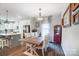 Open concept dining room with wooden table, modern light fixture and access to the kitchen at 25622 Seagull Dr # 645, Lancaster, SC 29720