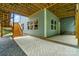 View of the home's exterior with a large concrete patio and a wooden deck with stairs at 25622 Seagull Dr # 645, Lancaster, SC 29720