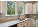 Bright kitchen features stainless sink, granite countertops, and large windows with backyard views at 25622 Seagull Dr # 645, Lancaster, SC 29720