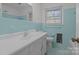 Bathroom with light blue tiled walls and a white vanity at 2810 Daleview Dr, Charlotte, NC 28214