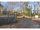 Grey deck and a large backyard with mature trees at 2810 Daleview Dr, Charlotte, NC 28214