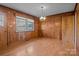 Dining room with wood paneled walls and hardwood floors at 2810 Daleview Dr, Charlotte, NC 28214