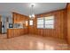 Dining room with wood paneled walls and hardwood floors at 2810 Daleview Dr, Charlotte, NC 28214