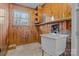 Laundry room with wooden paneling and utility sink at 2810 Daleview Dr, Charlotte, NC 28214