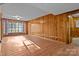 Spacious living area with wood walls and hardwood floors at 2810 Daleview Dr, Charlotte, NC 28214