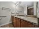 Bathroom with a granite countertop, double sink vanity, large mirror, and accessible grab bars, offers convenience and style at 4919 Polo Gate Blvd, Charlotte, NC 28216