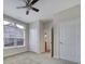 Bright bedroom with carpet, large window, and ceiling fan at 4919 Polo Gate Blvd, Charlotte, NC 28216