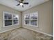 This bedroom with a ceiling fan and window views provides comfort and lets in an abundance of natural light at 4919 Polo Gate Blvd, Charlotte, NC 28216