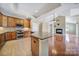 Open kitchen flows into the living area, boasting stainless appliances and granite counters at 4919 Polo Gate Blvd, Charlotte, NC 28216