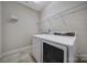 Bright laundry room featuring a modern washer and dryer set and convenient wire shelving for optimal storage at 4919 Polo Gate Blvd, Charlotte, NC 28216