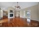 Spacious living room with a fireplace, hardwood floors, and access to a sunroom at 4919 Polo Gate Blvd, Charlotte, NC 28216