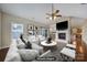 Virtually staged living room features fireplace and kitchen view at 4919 Polo Gate Blvd, Charlotte, NC 28216