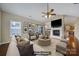 Cozy living room featuring a fireplace, hardwood floors, ceiling fan, and stylish decor at 4919 Polo Gate Blvd, Charlotte, NC 28216