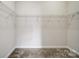 Empty walk-in closet offers an opportunity to organize clothes and shoes with adjustable shelving and lighting at 4919 Polo Gate Blvd, Charlotte, NC 28216