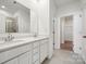 Modern bathroom with double vanity, quartz countertops, tile flooring and a glass-enclosed shower at 550 Mountain View Dr, Monroe, NC 28110