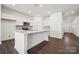 Modern kitchen features white cabinets, quartz countertops, a central island, and stainless steel appliances at 550 Mountain View Dr, Monroe, NC 28110