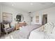 Bright bedroom featuring neutral decor, a decorative mirror, and comfortable furnishings at 550 Mountain View Dr, Monroe, NC 28110