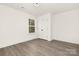 Bright bedroom with wood-look floors and closet at 8001 Willhill Rd, Charlotte, NC 28227