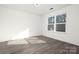 Sunny bedroom with wood-look floors and window at 8001 Willhill Rd, Charlotte, NC 28227