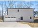 Two-car garage with white doors and a concrete driveway at 8001 Willhill Rd, Charlotte, NC 28227