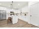 Modern kitchen with white cabinets, marble backsplash, and an island at 8001 Willhill Rd, Charlotte, NC 28227