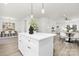 Kitchen island with white cabinets and a quartz countertop at 8001 Willhill Rd, Charlotte, NC 28227