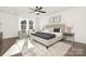 Spacious main bedroom with ceiling fan, large windows, and plush bedding at 8001 Willhill Rd, Charlotte, NC 28227