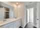 Bathroom with double vanity, white cabinets, and a walk-in shower at 9744 Inkberry Dr, Gastonia, NC 28056