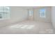 Well-lit bedroom with neutral carpeting and multiple windows at 9744 Inkberry Dr, Gastonia, NC 28056