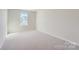 Bright bedroom with carpeted floor and a window at 9744 Inkberry Dr, Gastonia, NC 28056