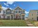 Modern two-story townhome with gray siding and a landscaped lawn at 9744 Inkberry Dr, Gastonia, NC 28056