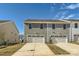 Rear view of townhouses with attached garages at 9744 Inkberry Dr, Gastonia, NC 28056