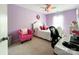 Cozy bedroom with lilac walls, white furniture, carpet flooring, and a ceiling fan at 1096 Mountain Laurel Ct, Matthews, NC 28104