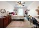 Bedroom features a light pink wall paint, ceiling fan, and carpet flooring at 1096 Mountain Laurel Ct, Matthews, NC 28104