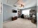 Bonus room featuring carpet flooring, a ceiling fan, storage shelving, and a desk at 1096 Mountain Laurel Ct, Matthews, NC 28104