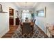 Elegant dining room featuring hardwood floors, a modern chandelier, and a view into the adjacent living spaces at 1096 Mountain Laurel Ct, Matthews, NC 28104