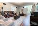 Open-concept living room featuring hardwood floors, comfortable seating, neutral paint, and seamless flow throughout at 1096 Mountain Laurel Ct, Matthews, NC 28104
