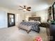 Spacious main bedroom with carpet floors, ceiling fan, and a king size bed at 1096 Mountain Laurel Ct, Matthews, NC 28104
