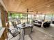 Inviting screened porch with a dining area and comfortable seating at 1096 Mountain Laurel Ct, Matthews, NC 28104