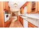 View of kitchen with wood cabinets, granite counters, and hardwood floors at 198 Dunlap Loop, Statesville, NC 28625
